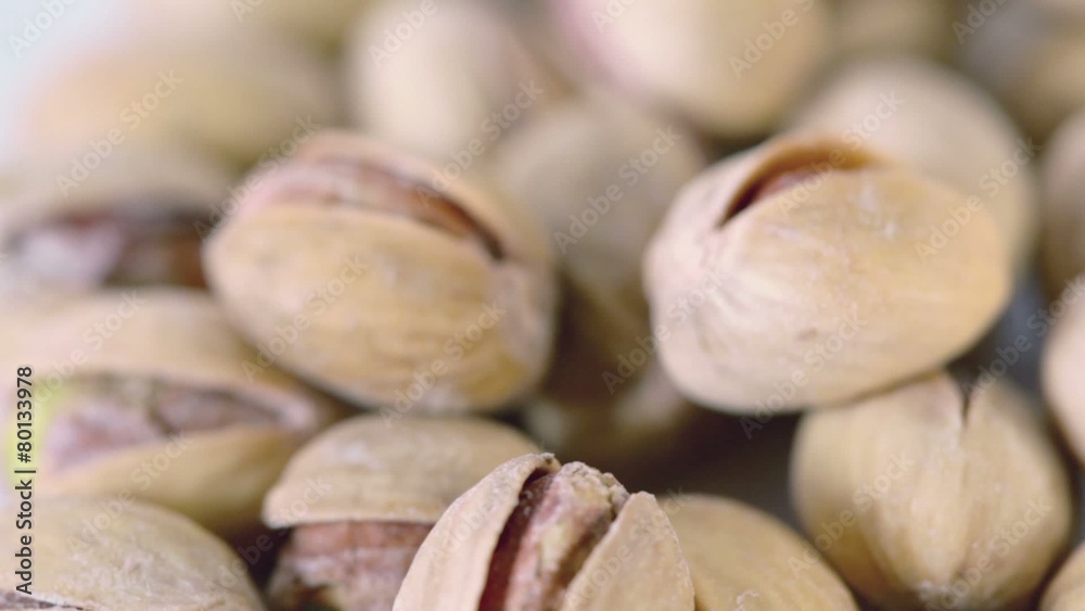 Handful of roasted salted appetizing pistachios spins closeup Handful of roasted salted appetizing pistachios spins closeup