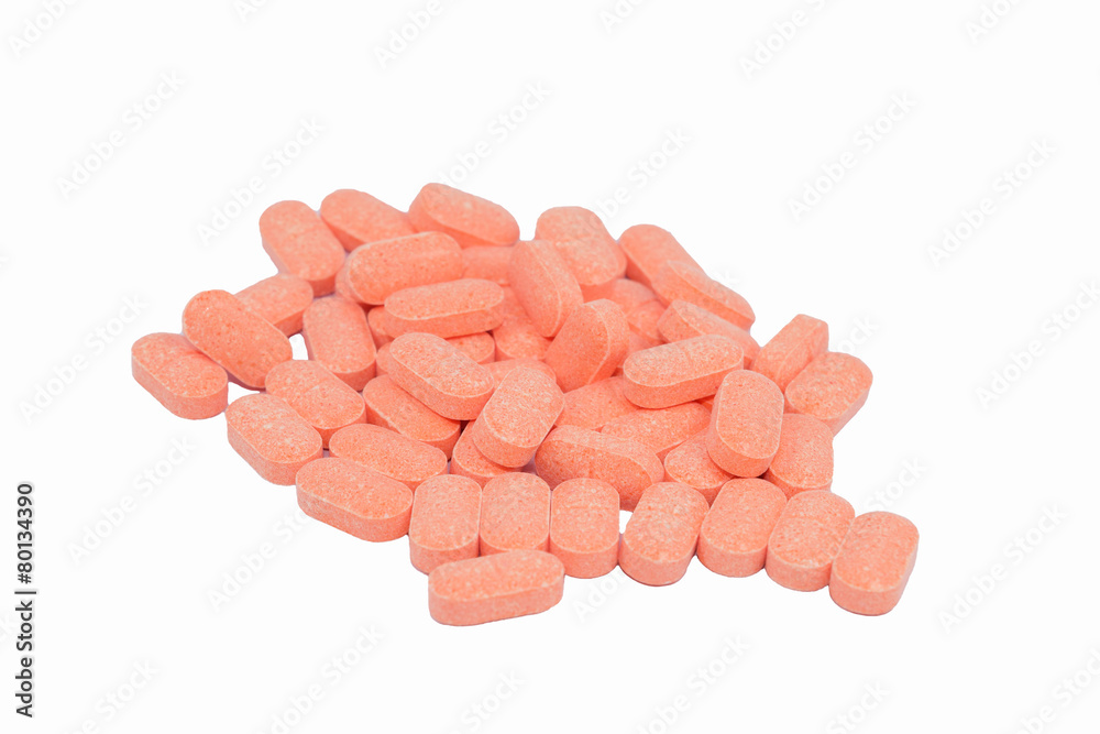 close up of orange pills isolated on white background close up of orange pills isolated on white background