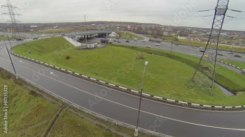 Cars ride by bridge of Abramtsevskaya overpass on Moscow beltway photo