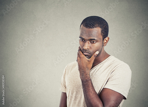 sad, depressed, worried young man looking down