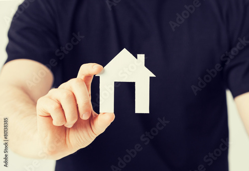 man hand holding paper house