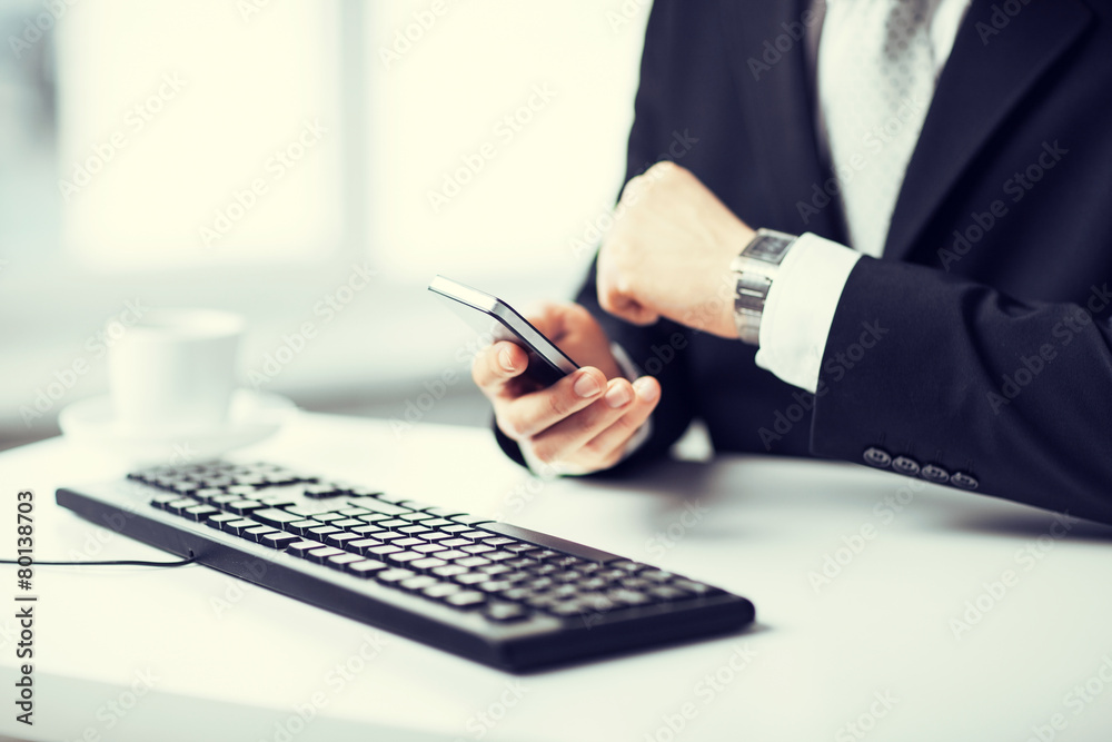 man hands with keyboard, smartphone and wristwatch man hands with keyboard, smartphone and wristwatch
