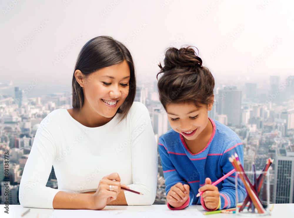 happy mother and daughter drawing with pencils happy mother and daughter drawing with pencils