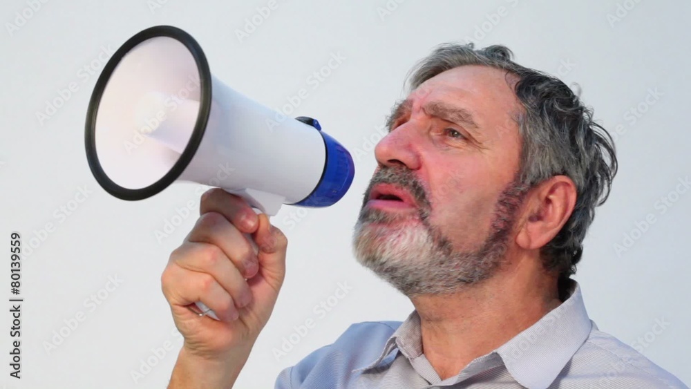 Senior man with beard speaks in megaphone, closeup Senior man with beard speaks in megaphone, closeup