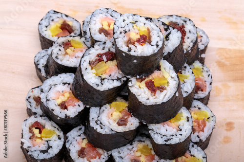 sushi fresh maki rolls isolated on wooden board