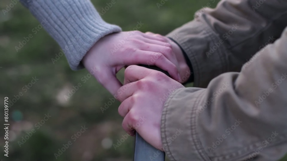 Couple holds hands, camera moves up to big close up of girl as they talk. Couple holds hands, camera moves up to big close up of girl as they talk.