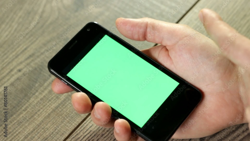 hand with a smartphone with green screen hand with a smartphone with green screen