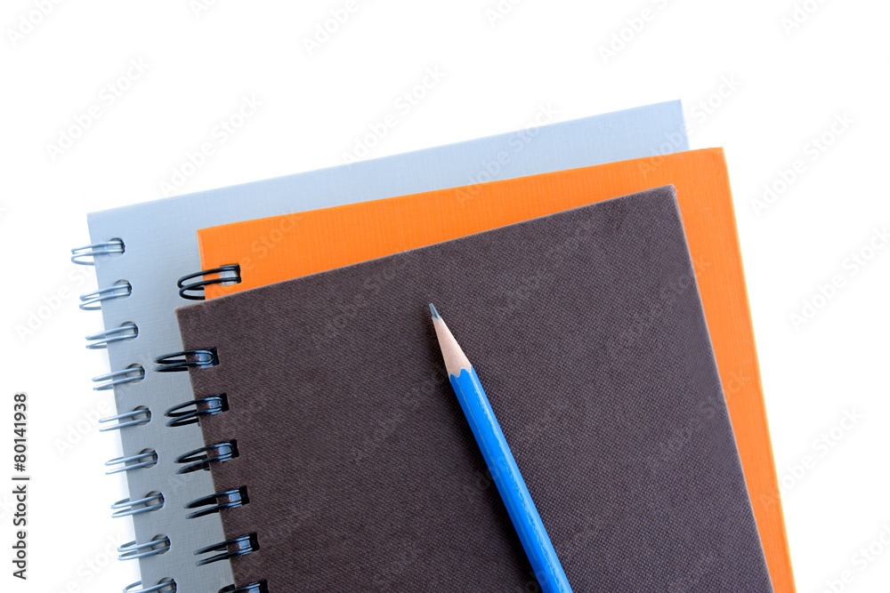 Stack of notebooks (or copybooks) with a pencil Stack of notebooks (or copybooks) with a pencil