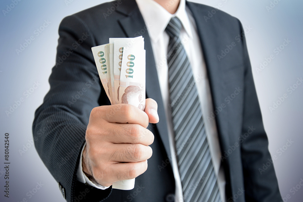 Businessman hand grabbing money - Thai Baht (THB) Businessman hand grabbing money - Thai Baht (THB)
