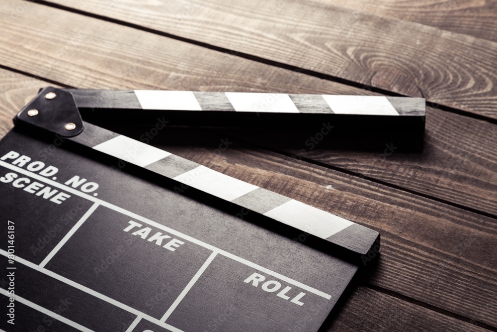 Naklejka premium Production. vintage photo of movie clapper on wood