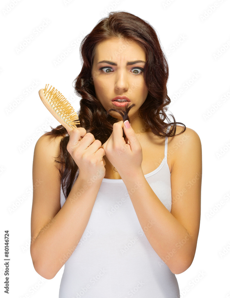 Young displeased girl with hair brush Young displeased girl with hair brush