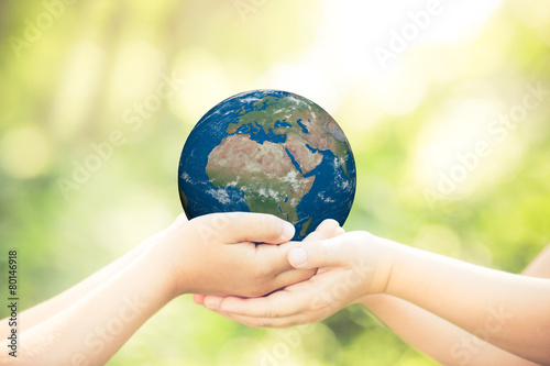 Fototapeta Naklejka Na Ścianę i Meble -  Child holding Earth planet in hands