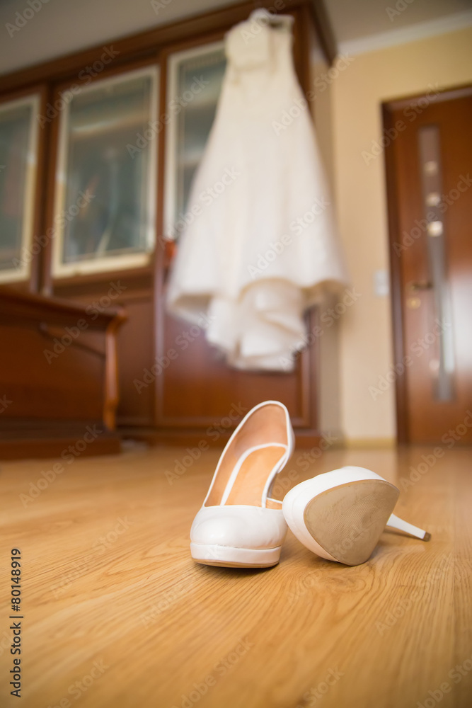 Wedding brides shoes and dress in morning room Wedding brides shoes and dress in morning room
