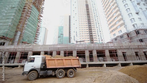 Truck rides backward at construction site of dwelling complex photo