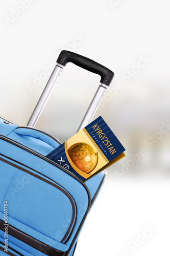 Kyrgyzstan. Blue suitcase with guidebook.