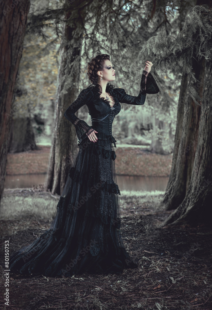 Woman in forest in black dress