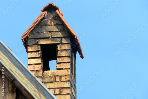 chimney with roof against blue sky, copy space