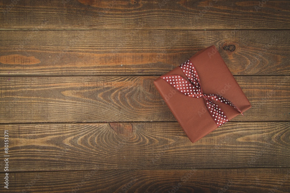 Fototapeta premium Gift. Vintage gift box with bow on wooden background