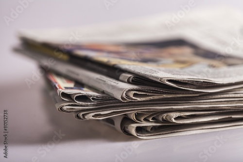 Press. Newspapers folded and stacked concept for global