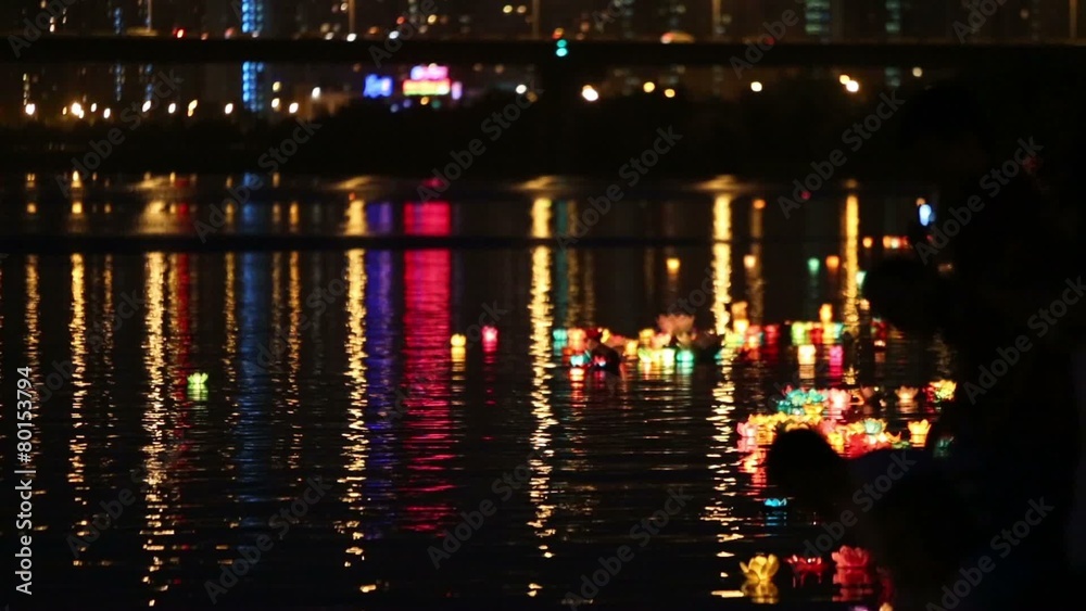 Many colored water lanterns float in water of river Many colored water lanterns float in water of river
