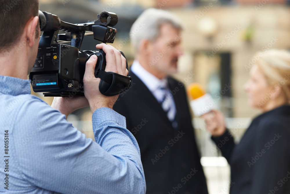 Cameraman Recording Female Journalist Interviewing Businessman Cameraman Recording Female Journalist Interviewing Businessman