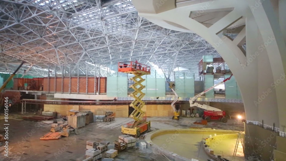 Scissor and telescopic lifts at construction site of terminal