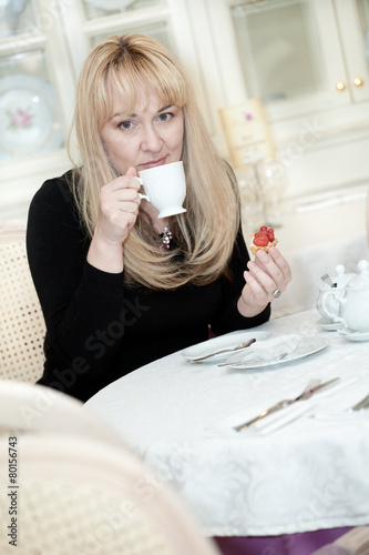 the blonde in a cafe interior