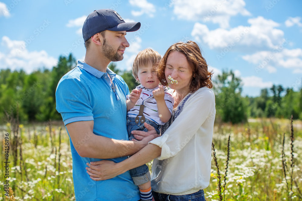 Obraz premium Young Attractive Parents and Child Portrait Outdoors