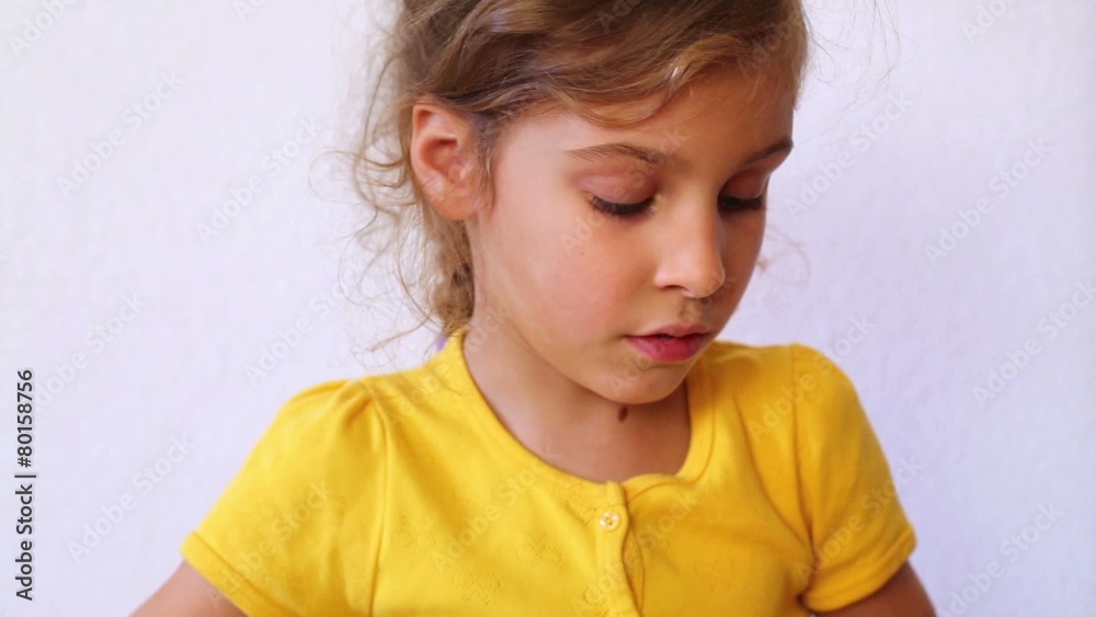 Little girl reads book pronouncing words Little girl reads book pronouncing words