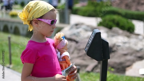 the girl with doll listening comment electronic guide in Istanbul, Turkey photo