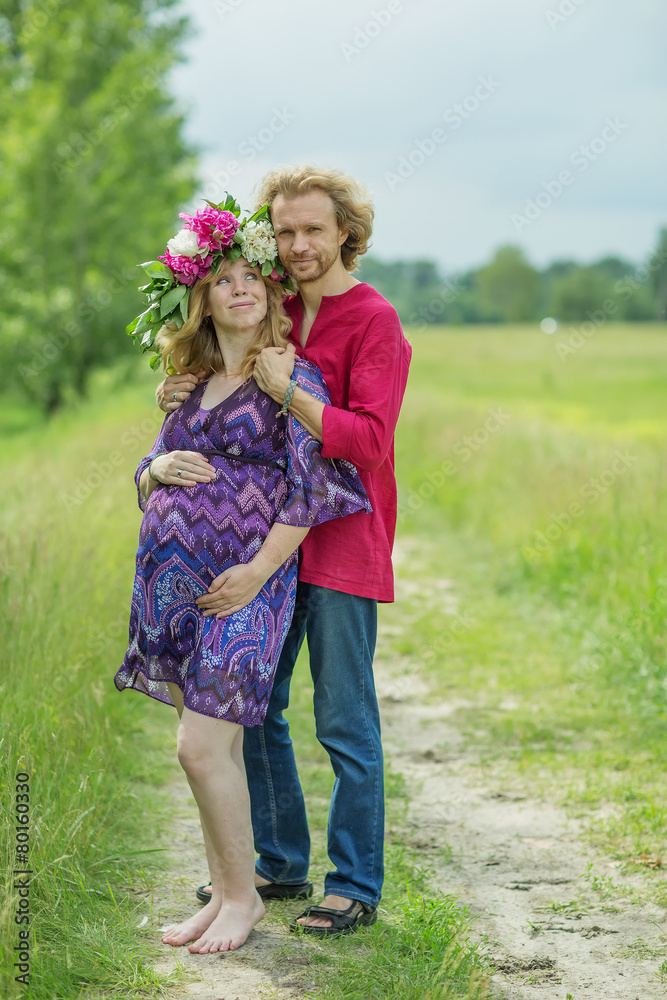Happy pregnant couple hugging in nature Happy pregnant couple hugging in nature