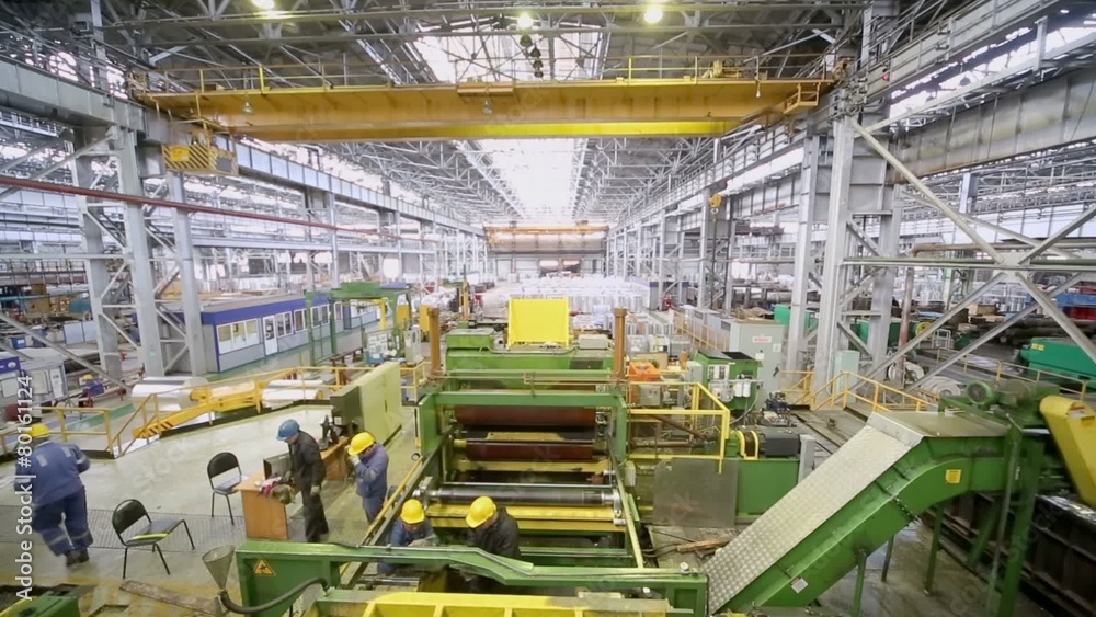People work at adjustment of complicated machine People work at adjustment of complicated machine
