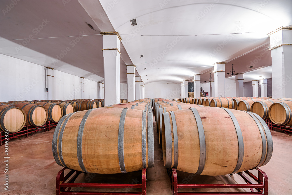 American oak barrels with red wine. Traditional wine cellar American oak barrels with red wine. Traditional wine cellar