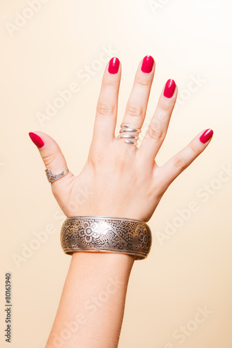 Принти на полотні Female hand with manicure and armlet