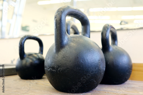 Large black kettlebells in weights room at the gym