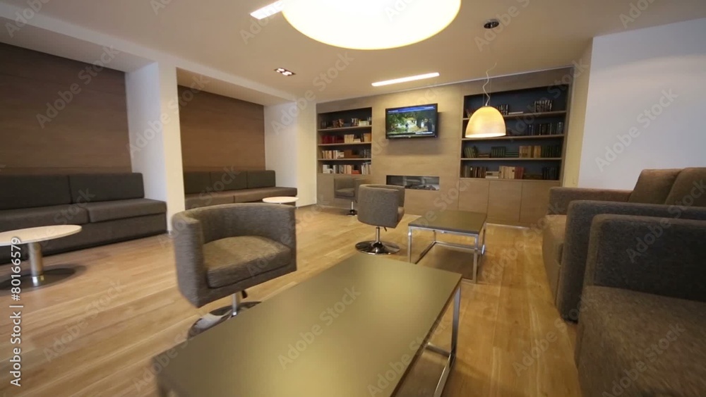 Rest-room with sofas, tv and bookcases at business center Rest-room with sofas, tv and bookcases at business center