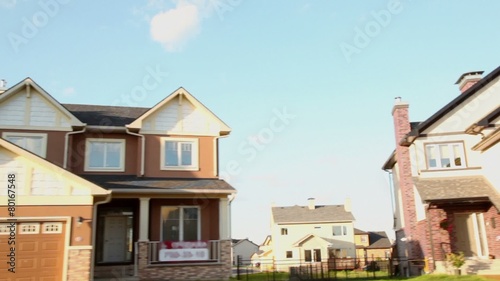 Several cottages in village under blue sky with clouds at sunny summer day, carview in motion photo