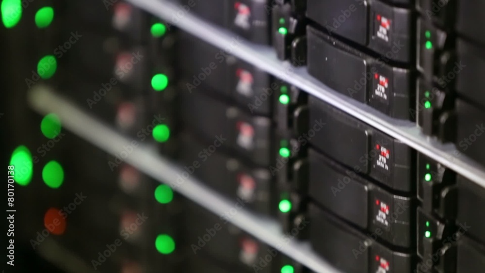 Rack of data server with many hard drives and LED lamps flashes