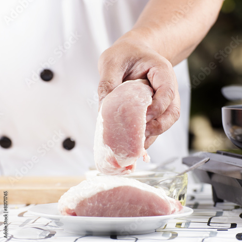 Chef holding raw pork