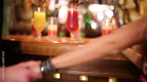 Legs of man and woman near bar counter and taking cocktails   photo