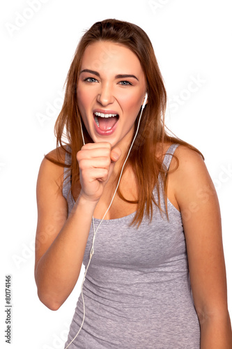 Young Beautiful Woman Listening and Singing Music,