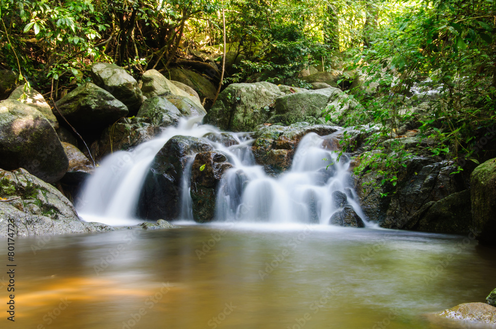 Little waterfalls in nature with stone wall