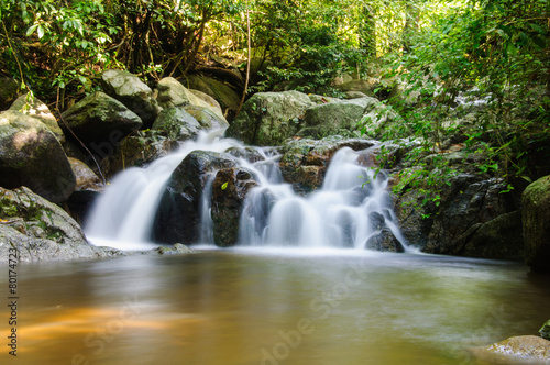 Fototapeta Naklejka Na Ścianę i Meble -  Little waterfalls in nature with stone wall
