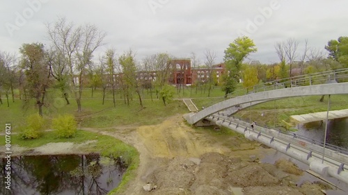 People walk by bridge over Cherkizovsky pond  photo