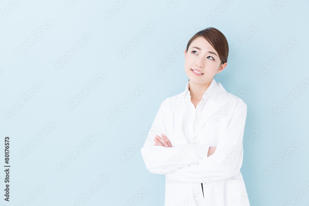 young asian doctor on blue background young asian doctor on blue background
