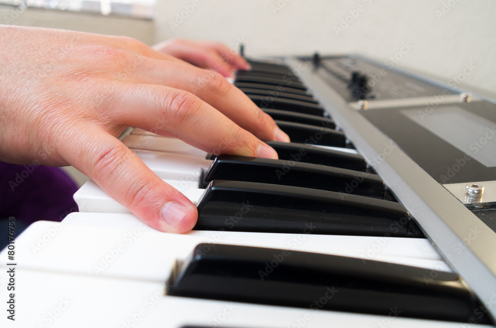 closeup photo of a person's hands playing piano closeup photo of a person's hands playing piano