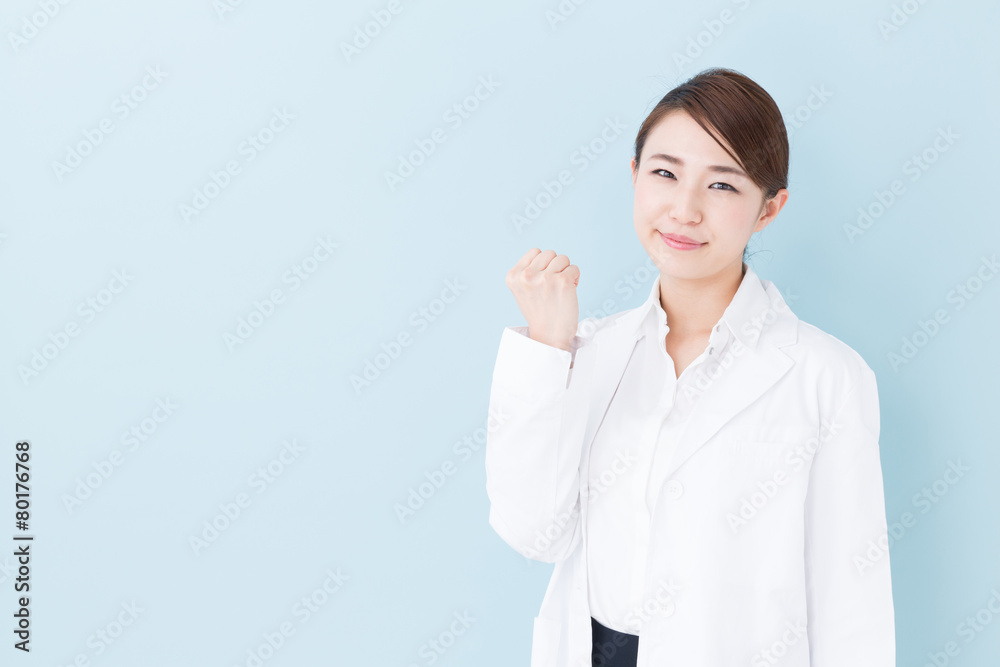 young asian doctor on blue background