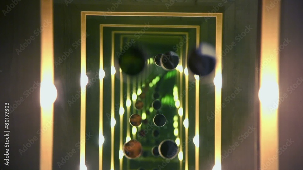 Eyes watch on tunnel which consists of mirror reflections