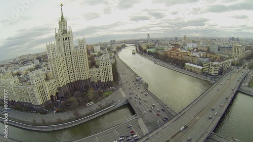 Cars ride by bridge and Kotelnicheskaya quay in Moscow photo