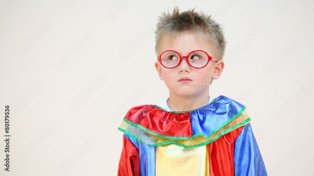Little boy in costume with glasses moving his eyes isolated Little boy in costume with glasses moving his eyes isolated